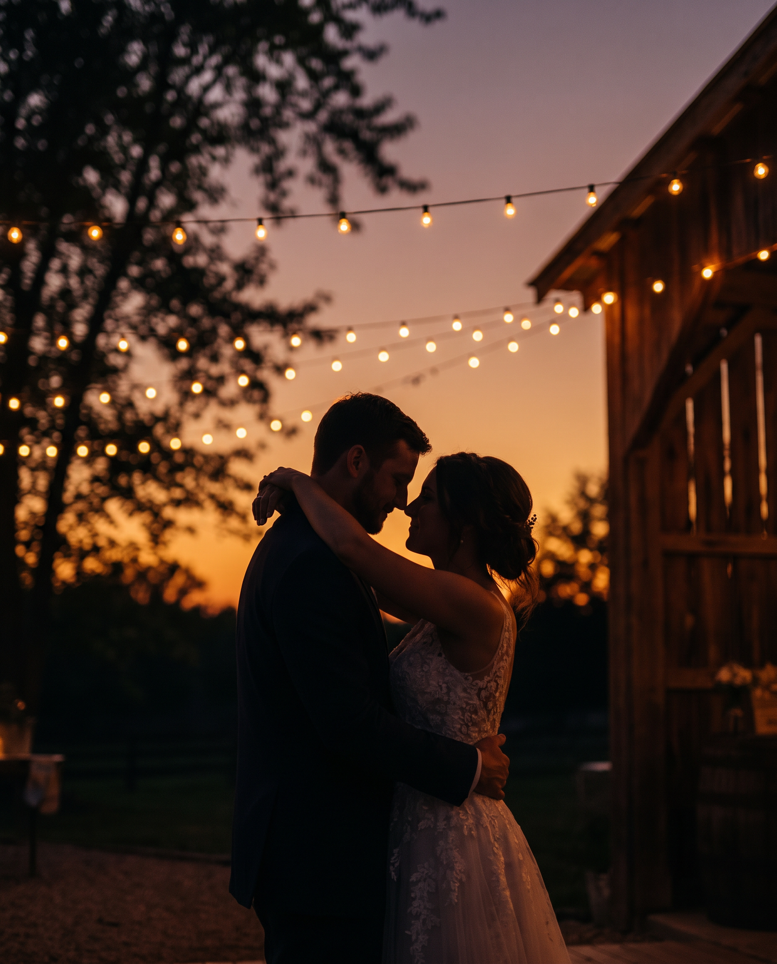 Couple's first dance under string lights